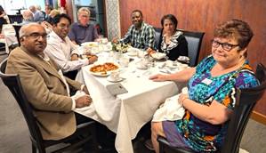 A group of people sitting around a tableDescription automatically generated