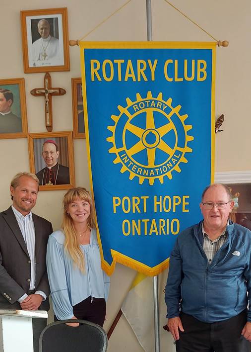 A group of people standing in front of a bannerAI-generated content may be incorrect.