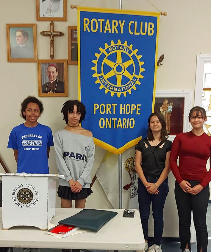 A group of people standing in front of a bannerAI-generated content may be incorrect.