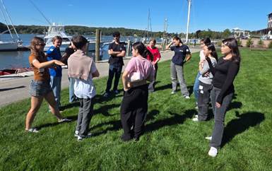 A group of people standing on grass
AI-generated content may be incorrect.