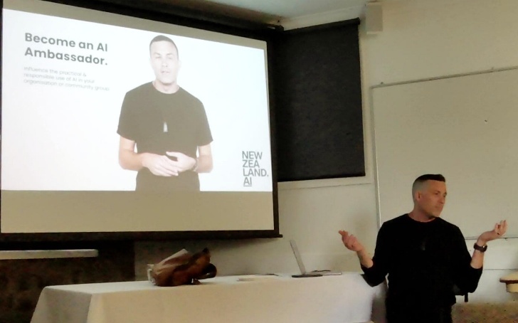 A person standing in front of a projector screenAI-generated content may be incorrect.