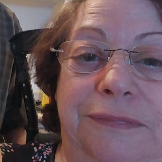 Close-up portrait of Mona Arsenault wearing glasses